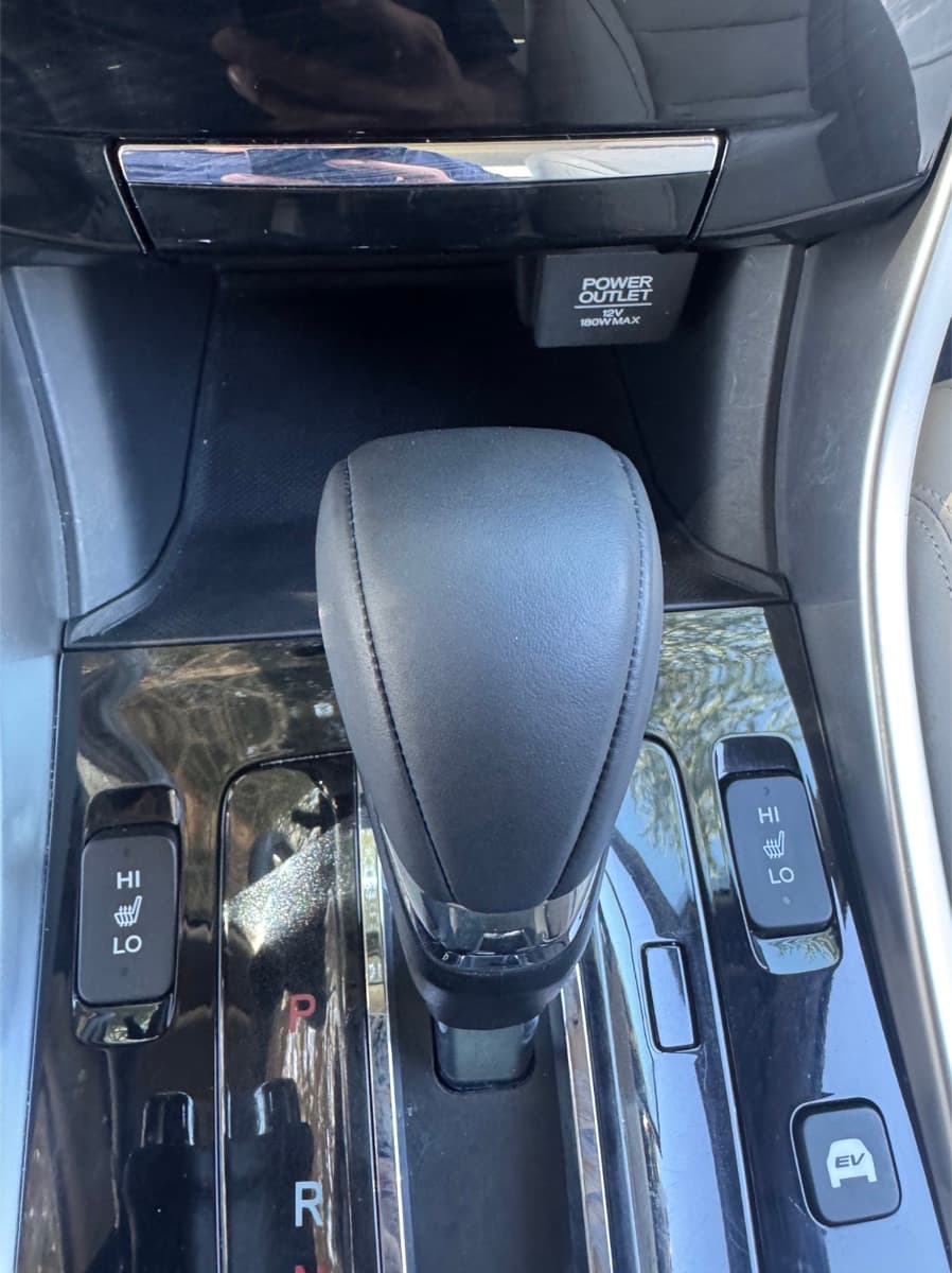 Same Honda shifter after conditioning — clean, restored leather