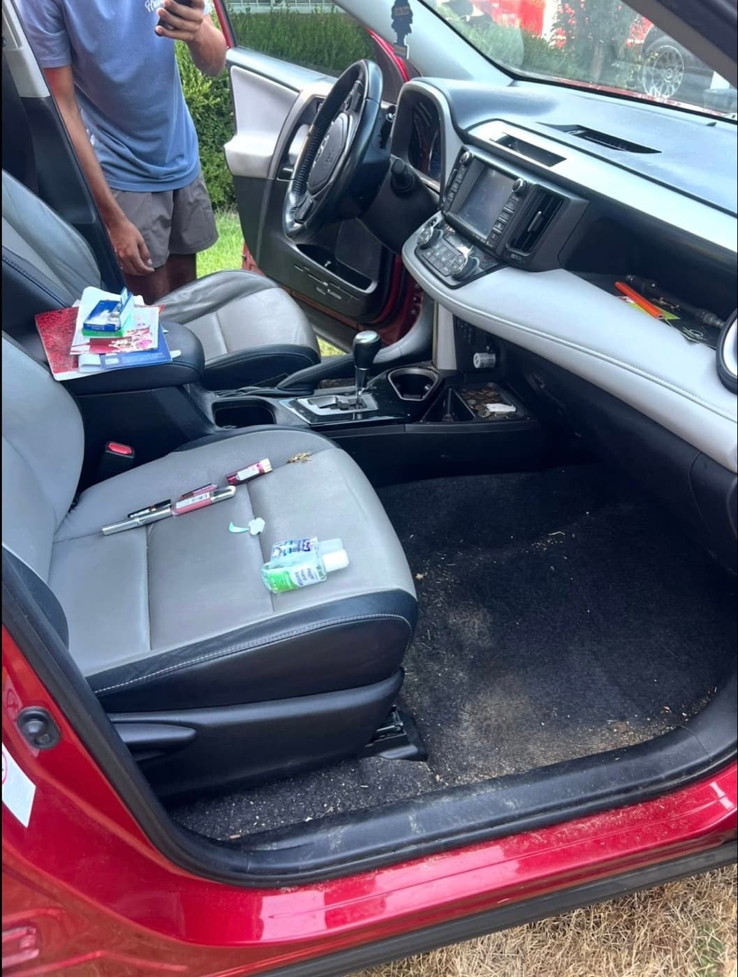 Toyota RAV4 cabin before — wrappers, books and crumbs on the seats and floor
