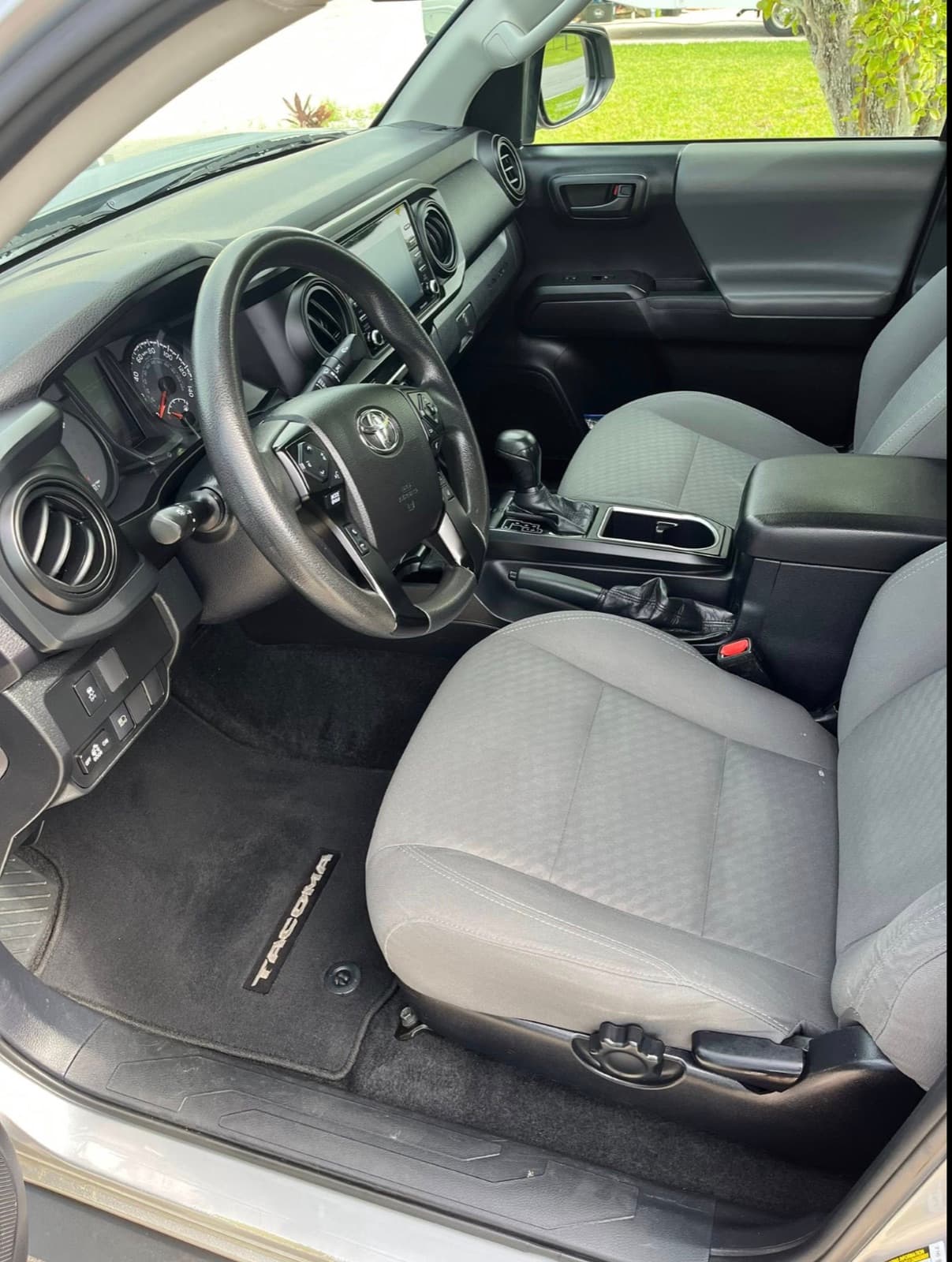 Toyota Tacoma cabin after a full interior detail — clean fabric seats, vacuumed floor mats, wiped console